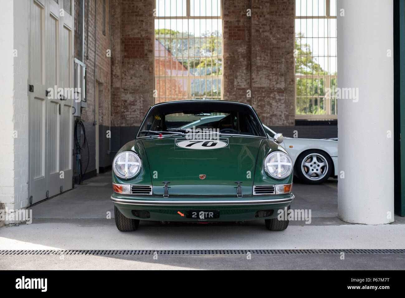 Porsche sports car in garage at Bicester heritage centre. Bicester, Oxfordshire, England Stock Photo