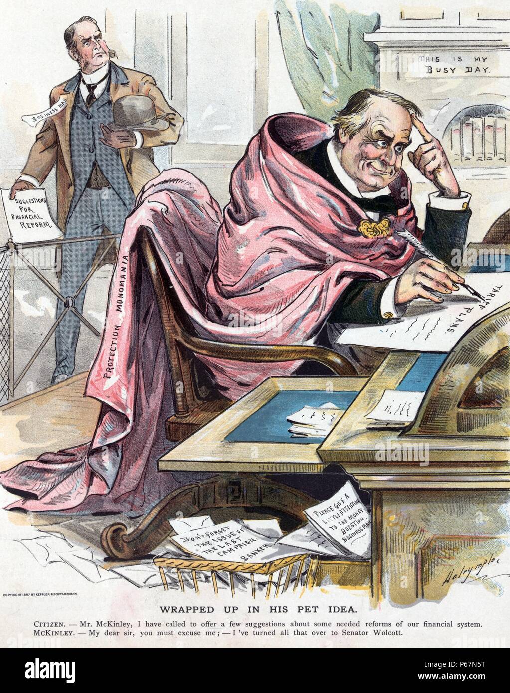 Wrapped up in his pet idea' President McKinley wearing a long cape labelled 'Protection Monomania', sitting at a desk working on his 'Tariff Plans', while ignoring a businessman who offers 'Suggestions for Financial Reform'; in baskets beneath the desk are papers that state 'Don't forget the issues of the last campaign. [signed] A Banker' and 'Please give a little attention to the money question. [signed] Businessman'. Stock Photo
