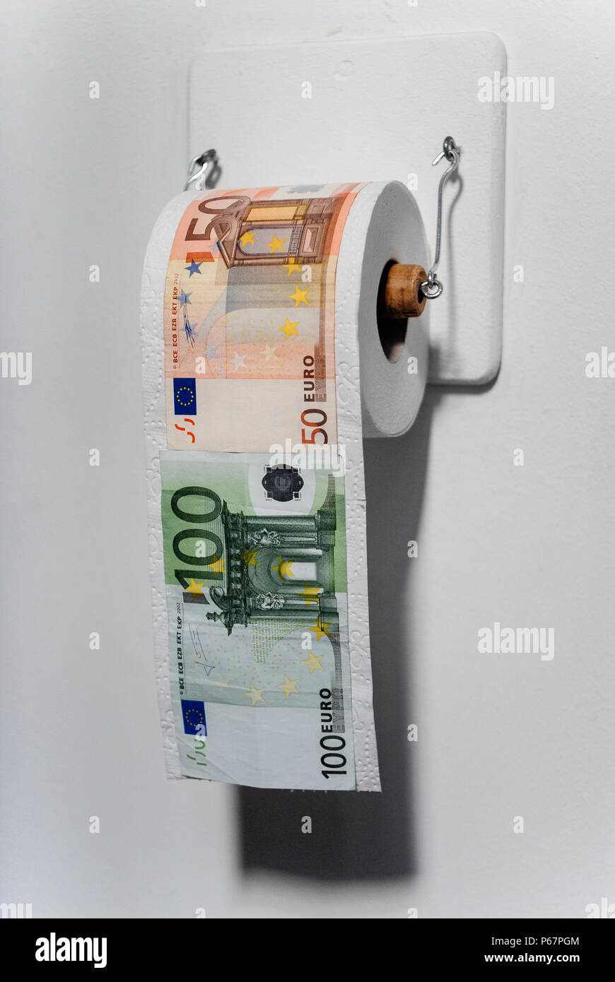 Germany, toilet paper roll with Euro banknotes Stock Photo Alamy