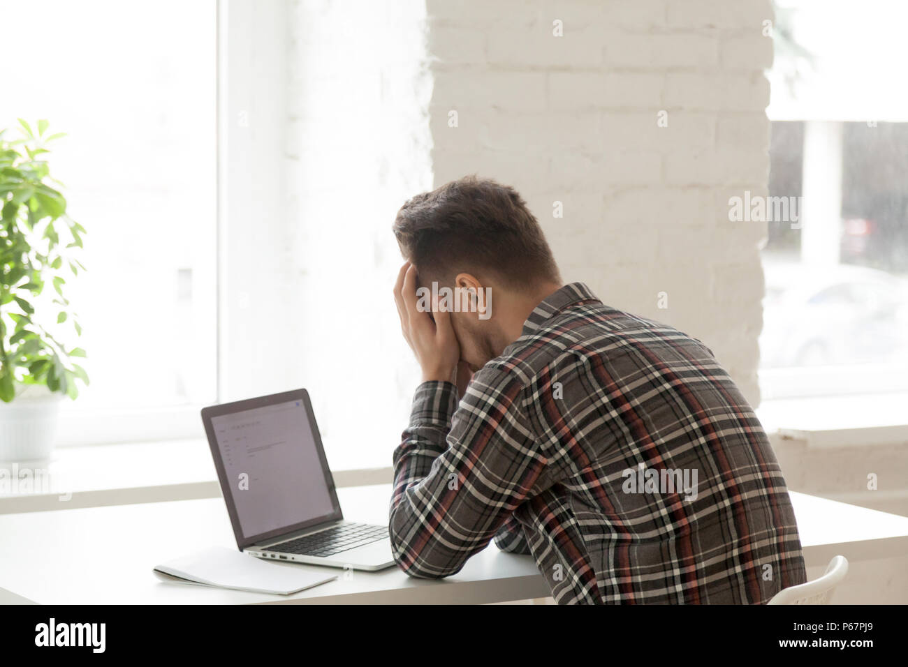 Depressed worker feeling down being fired via email Stock Photo Alamy