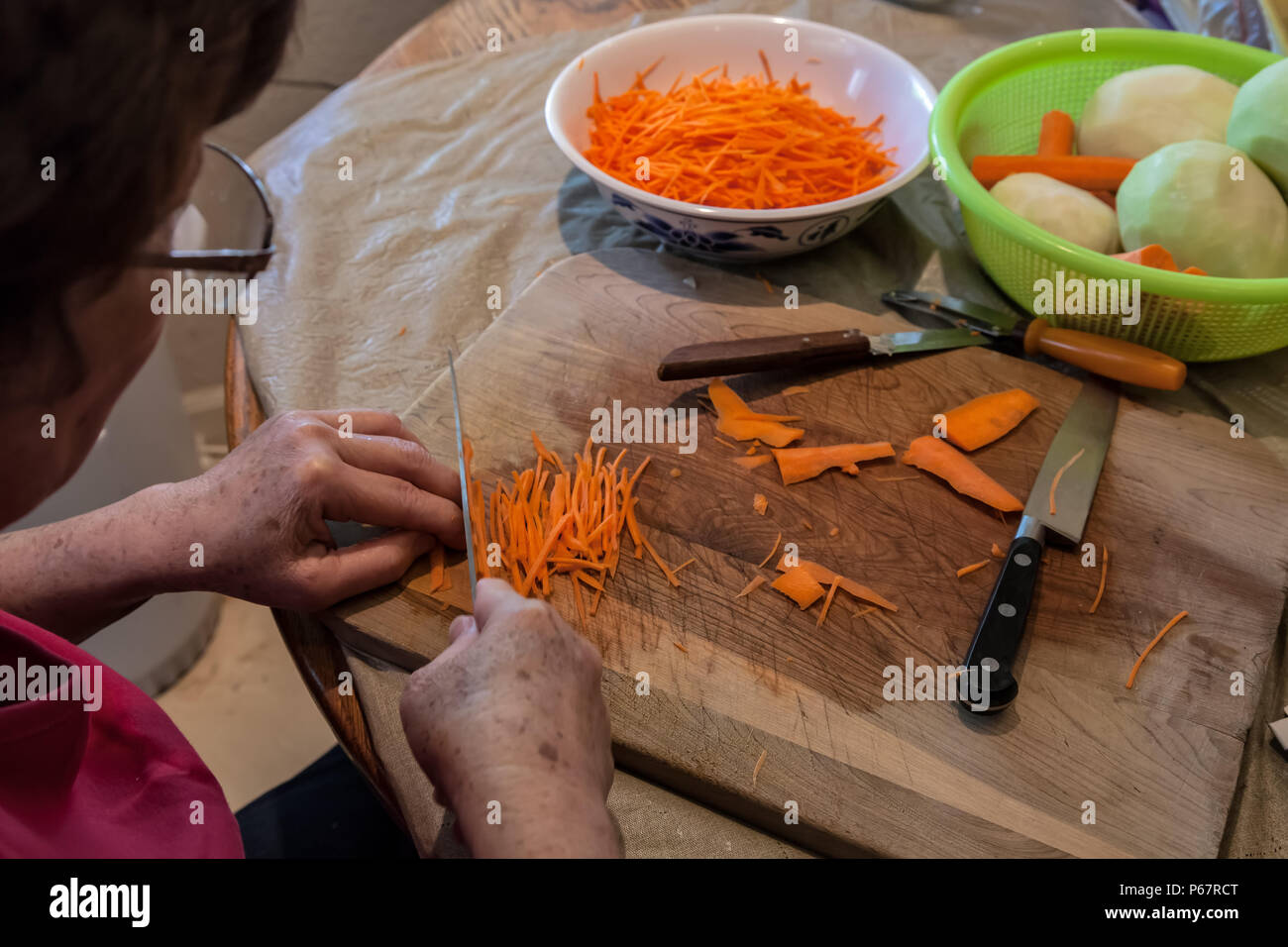 Asian woman was cutting carrots into Julienne for her Asian salad dish. Stock Photo
