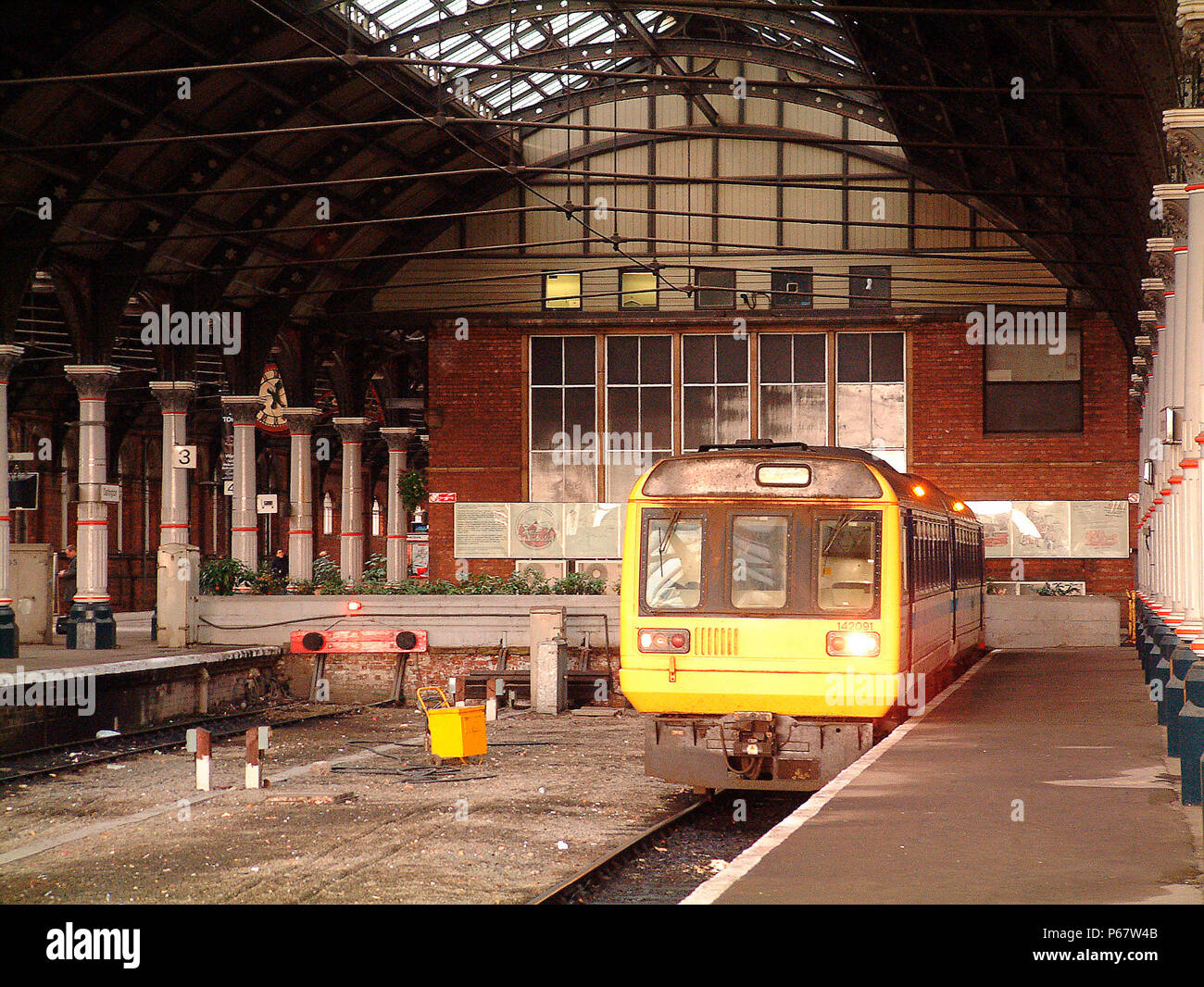 The cavernous interior of Darlington's ECML station dominates the Pacer unit waiting to depart with a local service to Saltburn. November 2003. Stock Photo