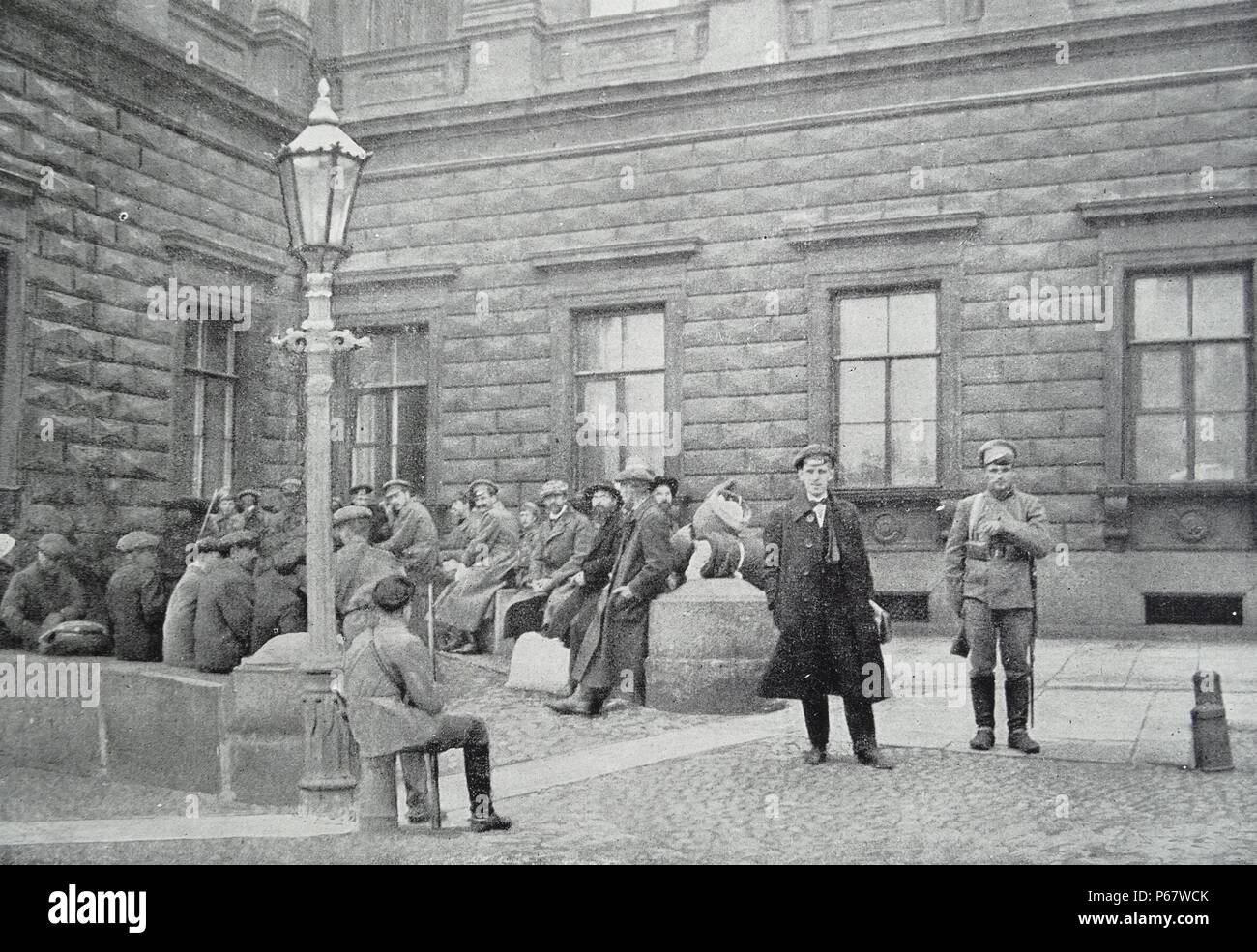 Group of hostages arrested by Red army soldiers in front of the Marie Palace in St Petersburg, Russia during the Russian Revolution September 1918 Stock Photo