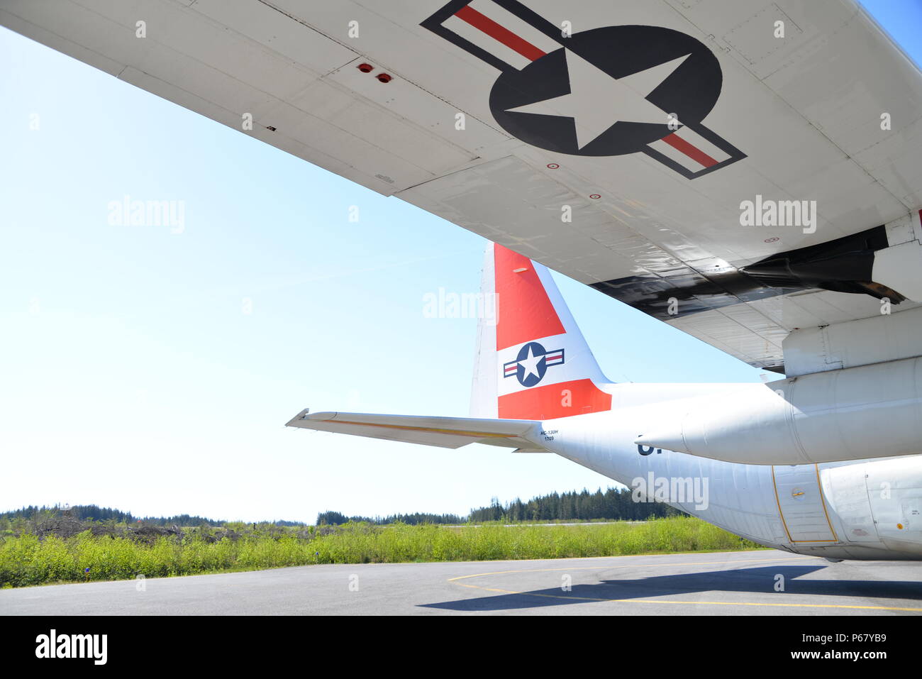 A Coast Guard HC-130 Hercules aircraft stands ready for deployment as the aircrew completes a logistics flight and delivery in Cordova, Alaska, May 13, 2016. Air Station Kodiak aircrews maintain a forward operating location in Cordova during the summer months to stand watch over the busy fishing and boating region. Stock Photo
