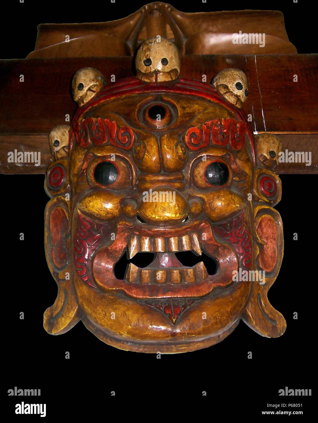 Ancient Tibet: Mahakala Mask, Late Qing Dynasty; 1800 - 1912 AD, from Lhasa, Tibet. A protective deity wth a crown of five skulls, the five wisdoms. Painted wood. Third eye on forehead. Stock Photo