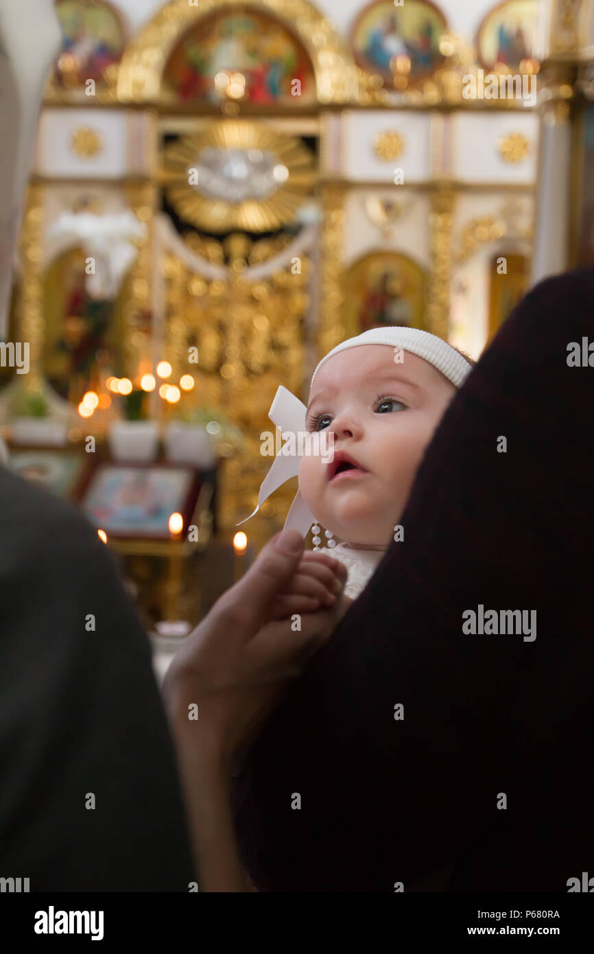 Belarus, Gomel, 25 March. 2018. The Prudhkovsky Church.A child at the rite of baptism. Accepting faith. Child in the Temple Stock Photo