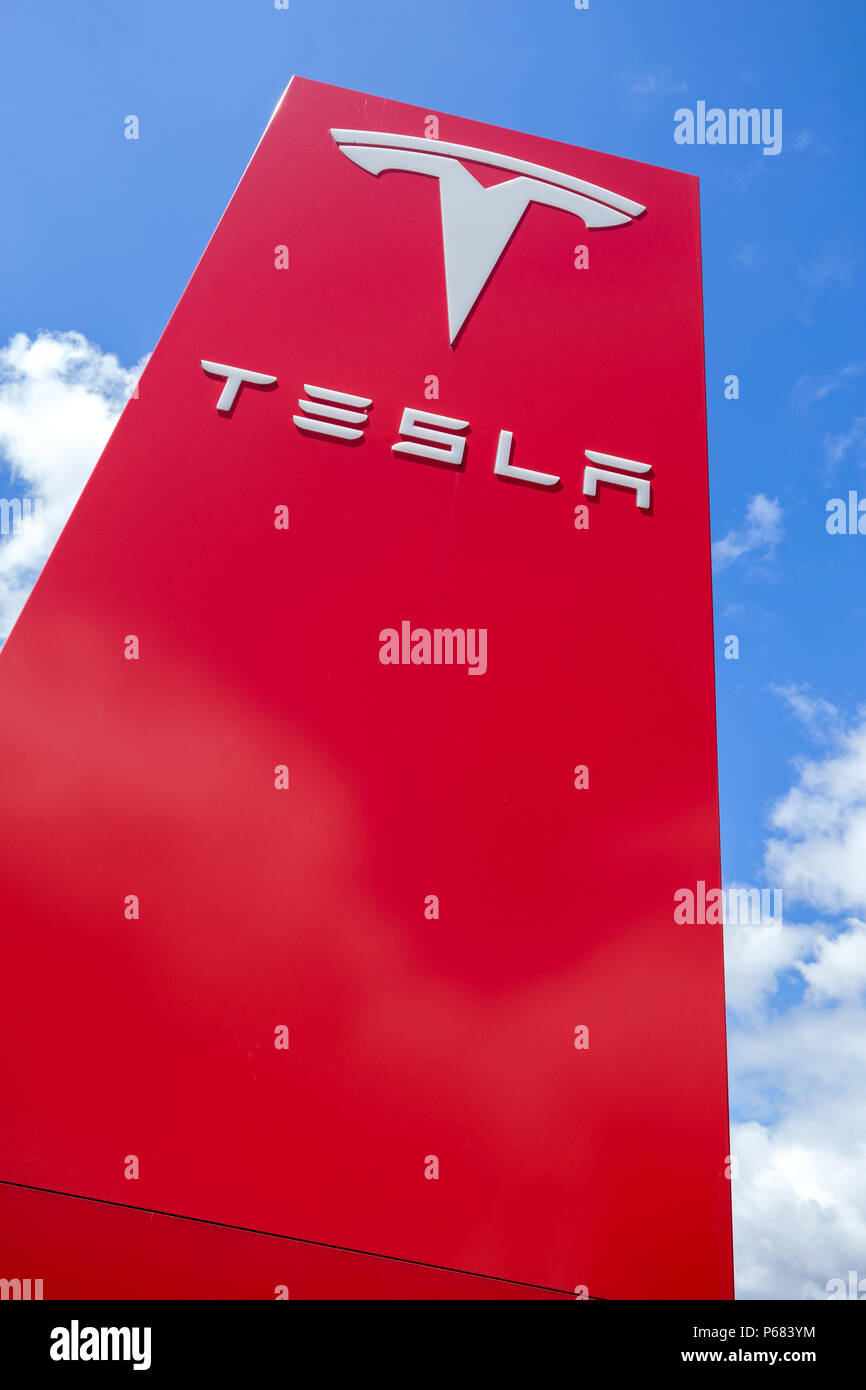 Tesla dealership sign against blue sky Stock Photo Alamy