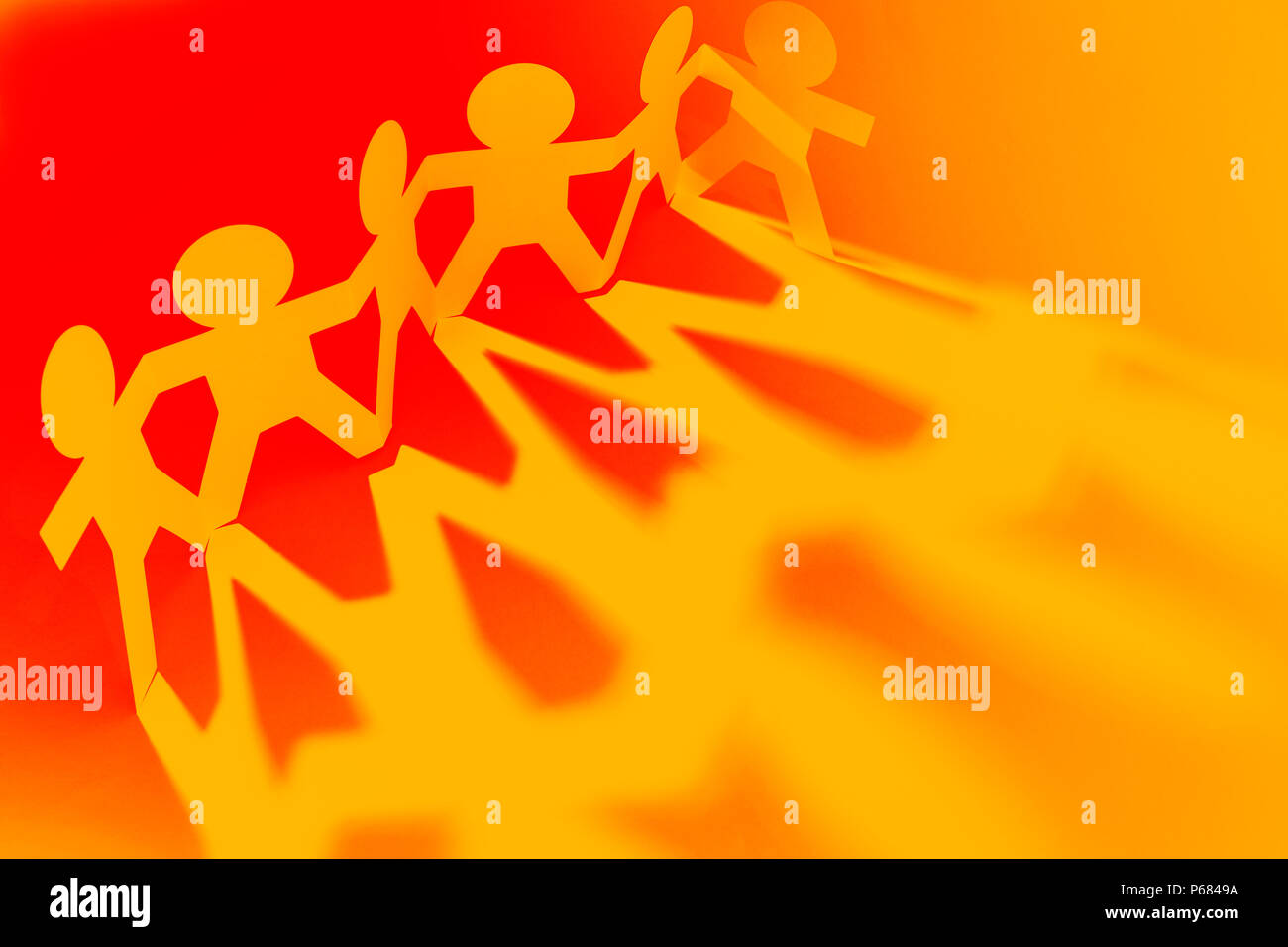 Team of paper chain people in a row holding hands Stock Photo - Alamy