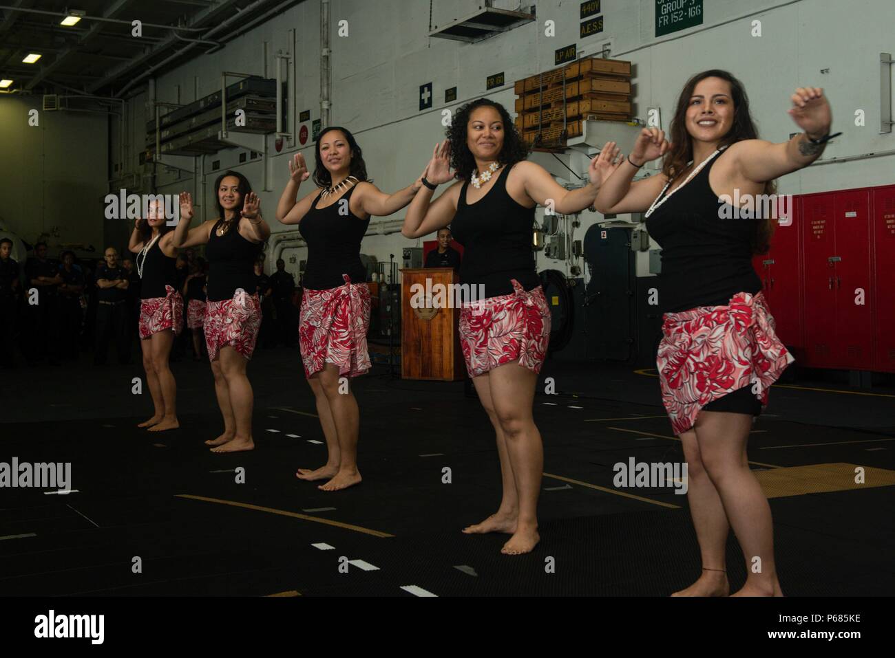 160528-N-MY174-084:  SOUTH CHINA SEA (May 28, 2016) - Sailors from USS John C. Stennis' (CVN 74) Multicultural Heritage Committee perform a Samoan cultural dance in the hangar bay. The performance was in celebration of Asian American and Pacific Islander Heritage Month. Providing a ready force supporting security and stability in the Indo-Asia-Pacific, John C. Stennis is operating as part of the Great Green Fleet on a regularly scheduled 7th Fleet deployment. (U.S. Navy photo by Mass Communication Specialist Seaman Tomas Compian/ Released) Stock Photo