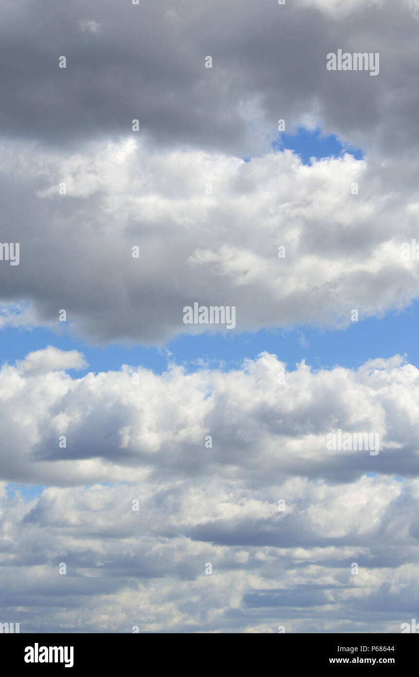 A blue sky with lots of white clouds of different sizes Stock Photo - Alamy