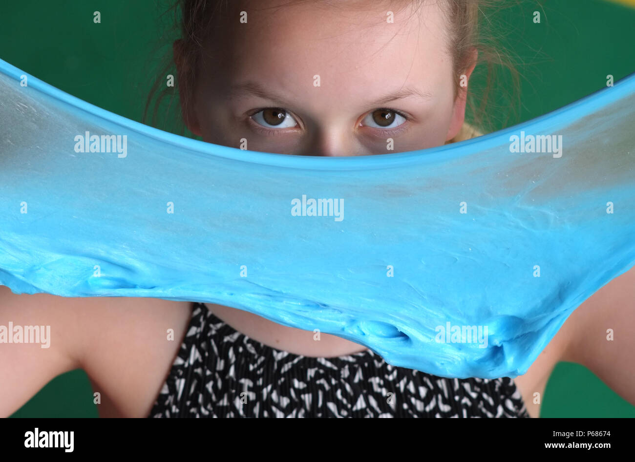 Young girl playing with homemade slime Stock Photo