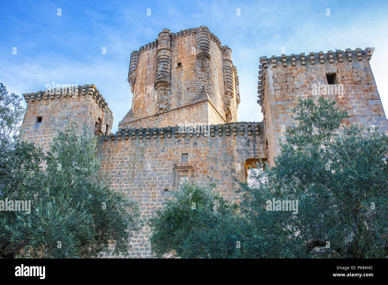 Impressive Belalcazar Castle between olive tree, with the highest keep tower of Iberian Peninsula, Cordoba, Spain Stock Photo