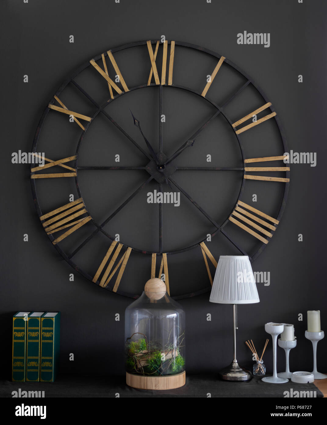 The Big Vintage Steel Clock Roman Numerals on The Black Wall with The