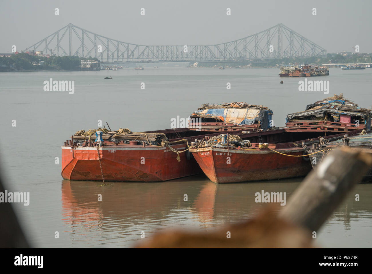 Howrah Bridge and barges on The Hooghly River Stock Photo