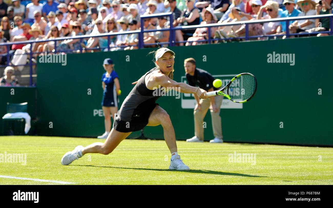 Caroline Wozniacki of Denmark stretches for a shot against Camila Giorgi of Italy during the Nature Valley International tennis tournament at Devonshire Park in Eastbourne East Sussex UK. 25 June 2018 Stock Photo