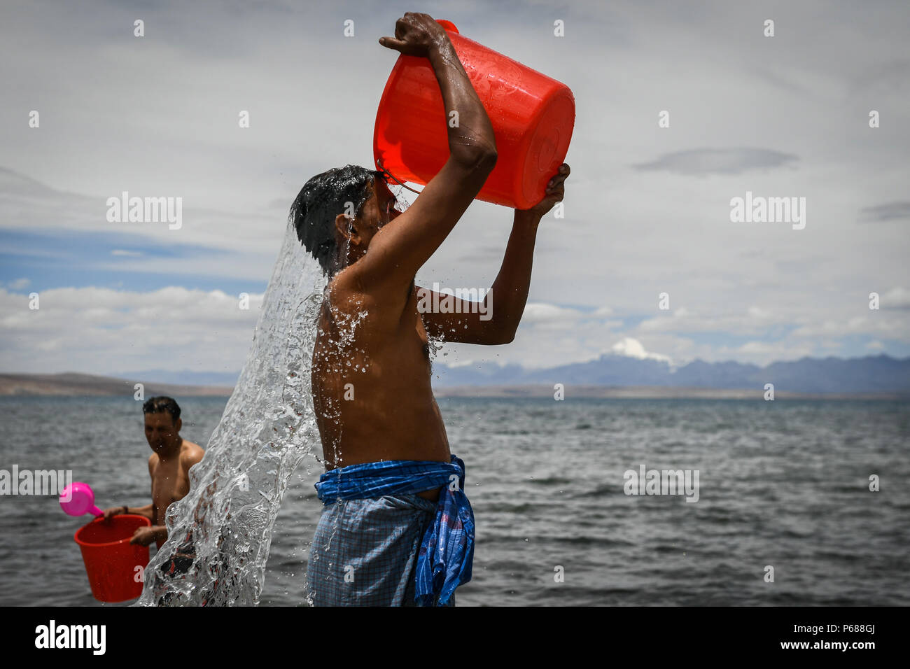 (180628) -- ALI, June 28, 2018 (Xinhua) -- Indian pilgrims take a bath at Mapam Yumco Lake, a sacred Hindu and Buddhist site, in Ali Prefecture, southwest China's Tibet Autonomous Region, June 26, 2018. This year, the Nathu La Pass is expected to see about 500 officially-organized pilgrims from India who will make the 2,874-km pilgrimage, according to Yang Zhigang, deputy director of the office of foreign affairs and overseas Chinese affairs in Xigaze City.  (Xinhua/Liu Dongjun)(mcg) Stock Photo