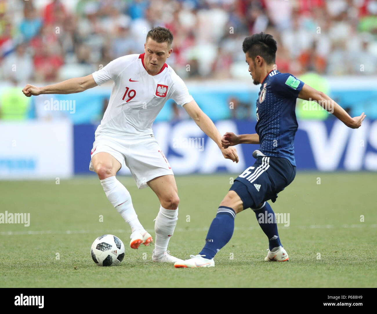 Volgograd, Russia. 28th June, 2018. Piotr Zielinski (L) of Poland vies with Hotaru Yamaguchi of Japan during the 2018 FIFA World Cup Group H match between Japan and Poland in Volgograd, Russia, June 28, 2018. Credit: Wu Zhuang/Xinhua/Alamy Live News Stock Photo