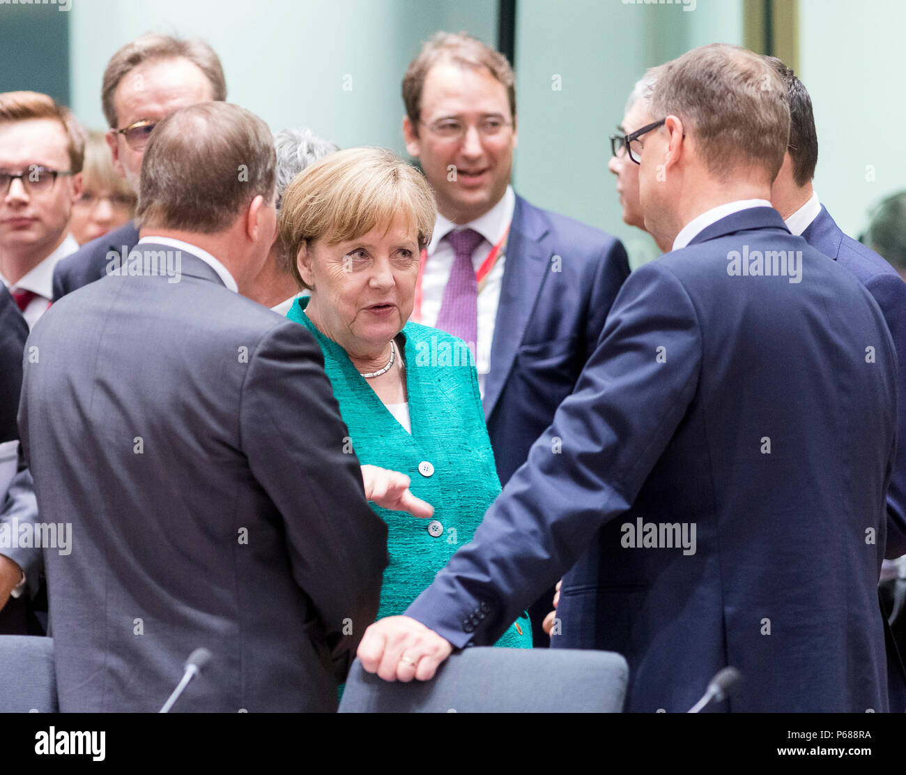 Brussels, Belgium. 28th June, 2018. German Chancellor Angela Merkel (C) talks with European leaders at the first day of a two-day EU Summit in Brussels, Belgium, June 28, 2018. Credit: Thierry Monass/Xinhua/Alamy Live News Stock Photo