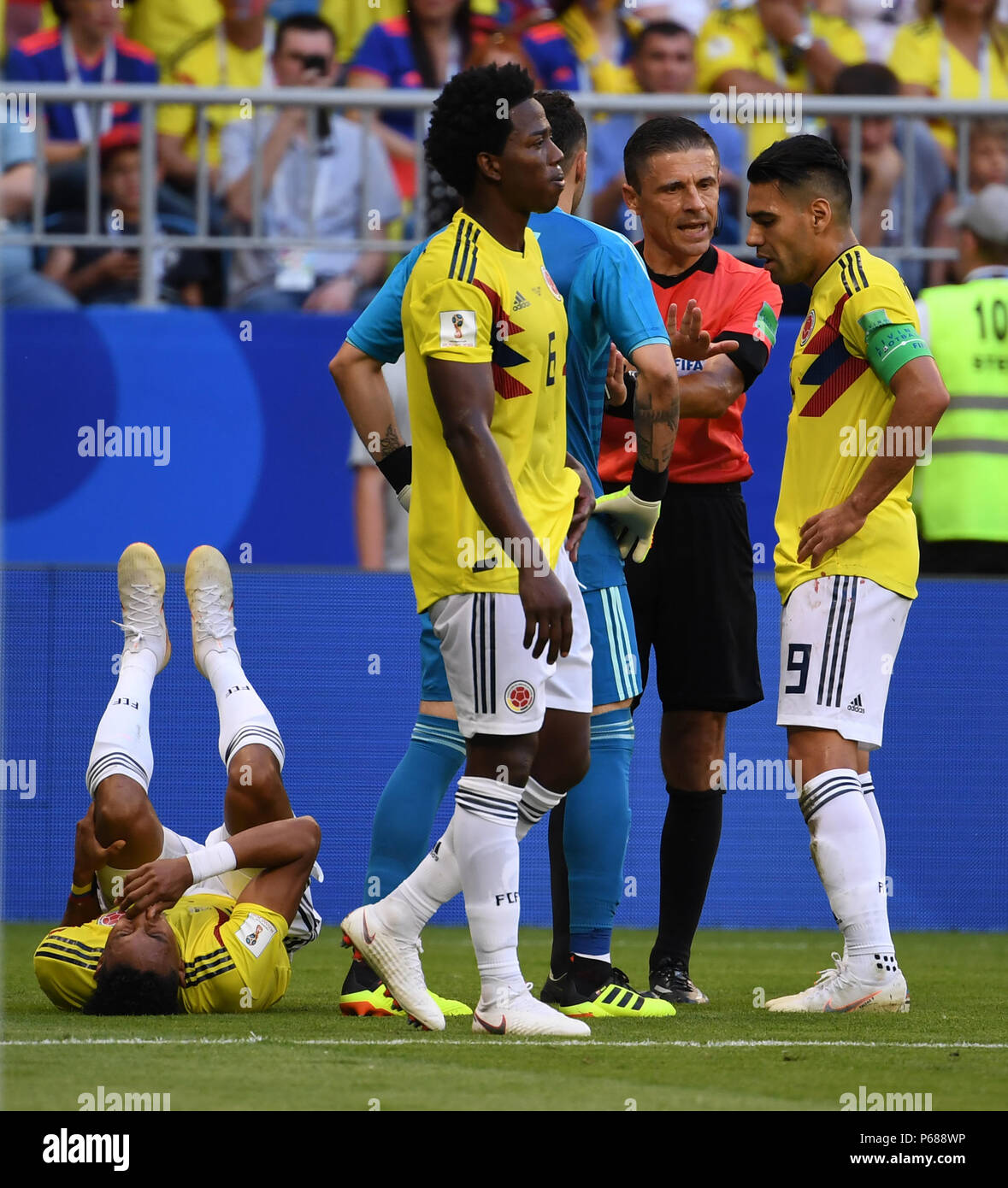 Samara, Russia. 28th June, 2018. Johan Mojica (1st L) of Colombia lies on the pitch after his injury during the 2018 FIFA World Cup Group H match between Colombia and Senegal in Samara, Russia, June 28, 2018. Credit: Chen Cheng/Xinhua/Alamy Live News Stock Photo