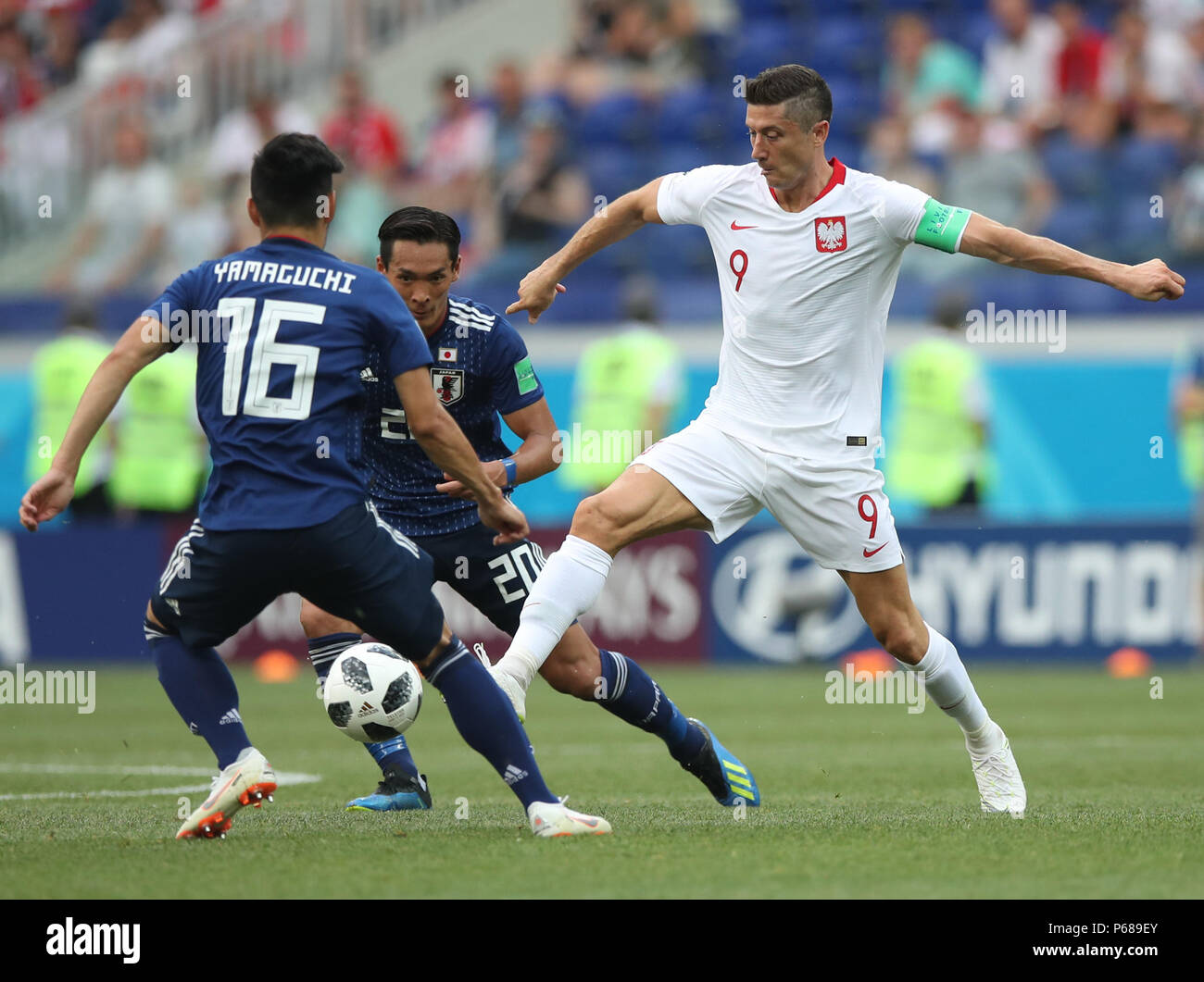 Volgograd, Russia. 28th June, 2018. Robert Lewandowski (R) of Poland vies with Hotaru Yamaguchi (L) and Tomoaki Makino of Japan during the 2018 FIFA World Cup Group H match between Japan and Poland in Volgograd, Russia, June 28, 2018. Credit: Wu Zhuang/Xinhua/Alamy Live News Stock Photo