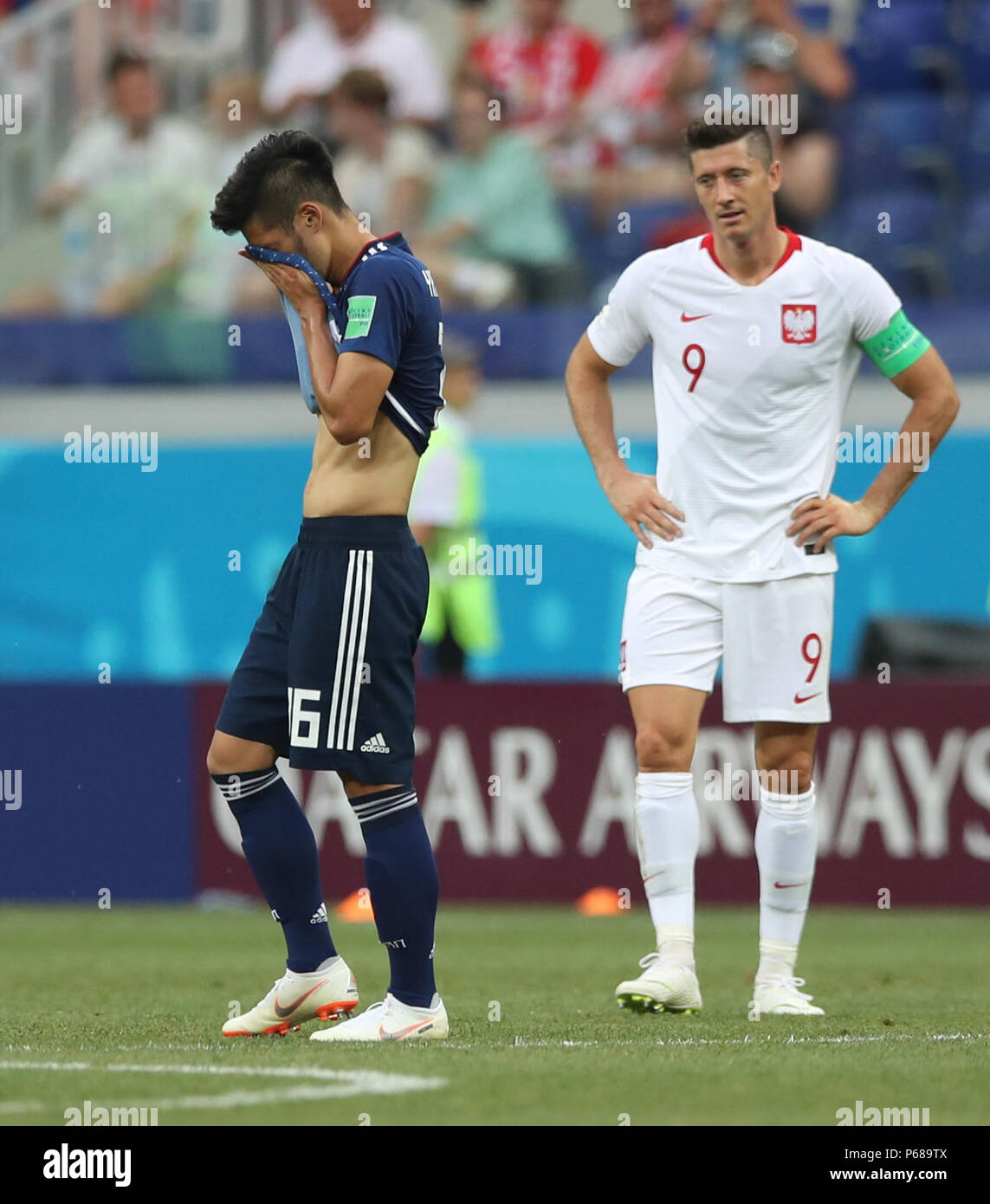 Volgograd, Russia. 28th June, 2018. Hotaru Yamaguchi (L) of Japan and Robert Lewandowski of Poland react after the 2018 FIFA World Cup Group H match between Japan and Poland in Volgograd, Russia, June 28, 2018. Poland won 1-0. Japan advanced to the round of 16. Credit: Wu Zhuang/Xinhua/Alamy Live News Stock Photo