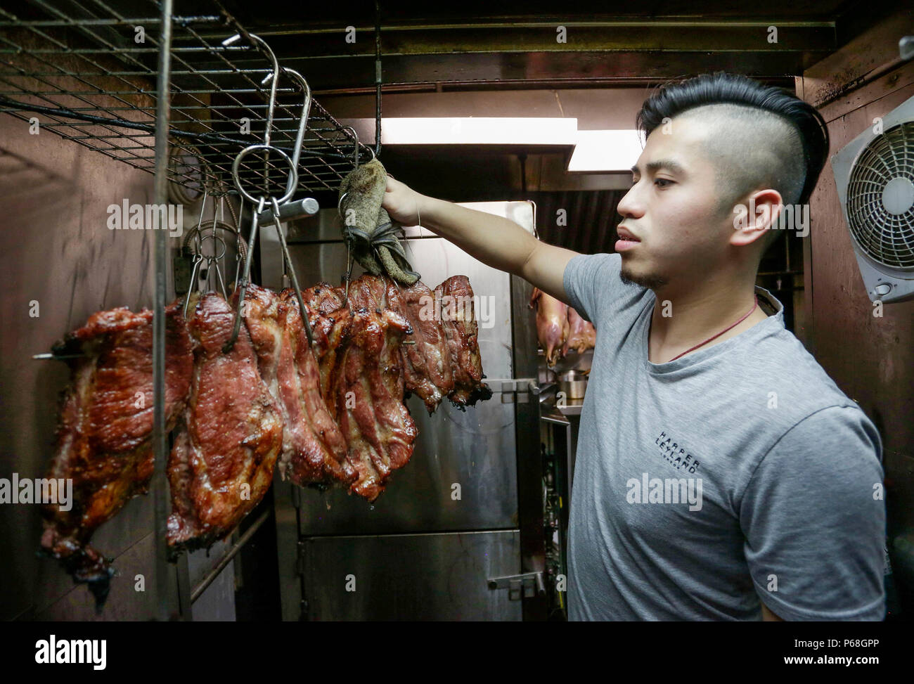 Vancouver, Canada. 28th June, 2018. Anson Leung prepares barbecue meat