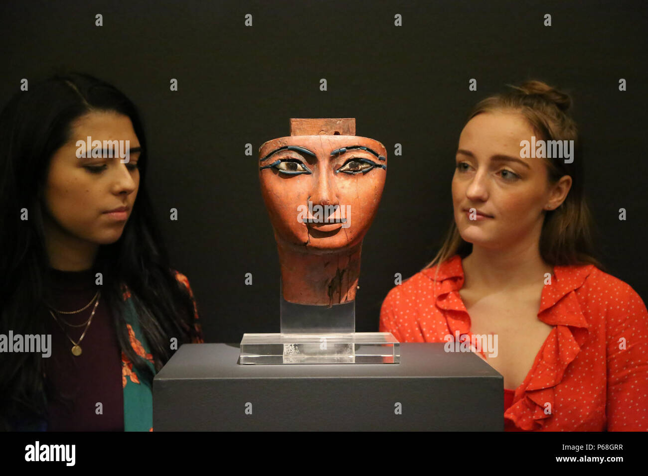 Sotheby's London. UK 29 June 2018 - Two women looks at Ab Egyptian polychrome Wood Mummy Mask, 21st/22nd Dynasty, 1075-716 B.C (Est £100,000 - 150,000). Old master & British paintings and drawings, decorative arts, sculptures and antiquities spanning over two Millennia on auction at Sotheby's London.   Credit: Dinendra Haria/Alamy Live News Stock Photo