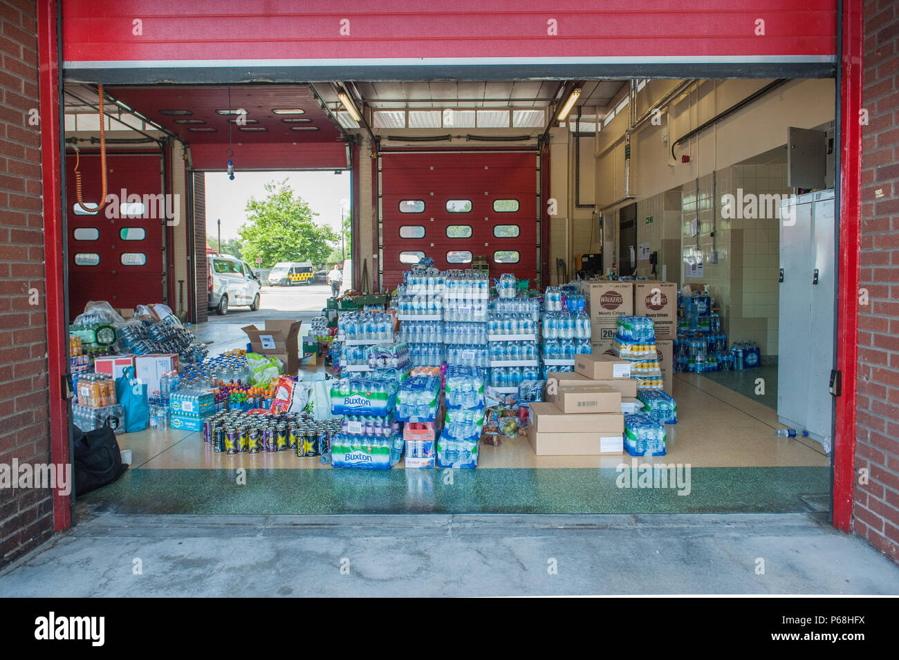 Stalybridge Fire Station, Greater Manchester, UK. 29th June, 2018. Supplies including water and food given by the public and local businesses for the needs of firefighters tackling the huge blaze on Saddleworth Moor, at Stalybridge Fire Station, Greater Manchester on Friday 29th June 2018. Credit: Matthew Wilkinson/Alamy Live News Stock Photo