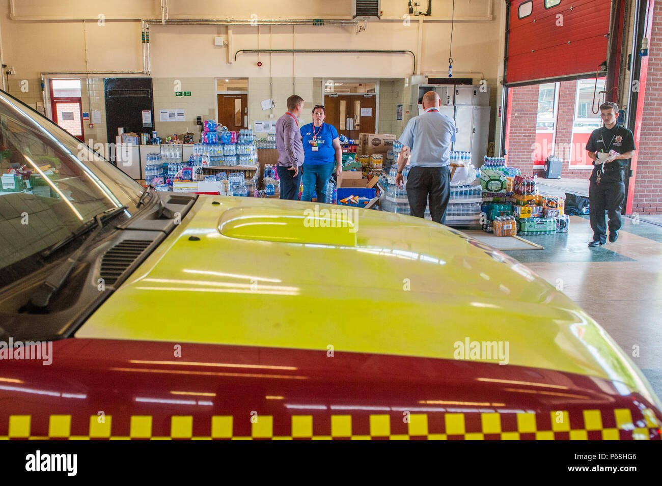 Stalybridge Fire Station, Greater Manchester, UK. 29th June, 2018. Staff and volunteers sort through a deluge of supplies including water and food given by the public and local businesses for the needs of firefighters tackling the huge blaze on Saddleworth Moor, at Stalybridge Fire Station, Greater Manchester on Friday 29th June 2018. Credit: Matthew Wilkinson/Alamy Live News Stock Photo