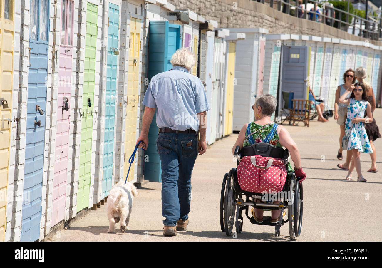Lyme Regis, Dorset, UK. 29th June, 2018. UK Weather: Visitors and locals flock to the beach to enjoy more hot sunshine and clear blue sky in the seaside resort of Lyme Regis as the record breaking temperatures are set to continue into July. People take an afternoon stroll along the seafront. Credit: DWR/Alamy Live News Stock Photo
