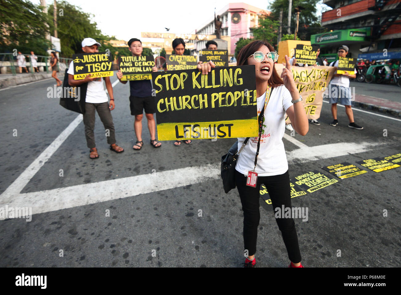 Manila, Philippines. 29th June, 2018. Students from the University of Santo Thomas staged a lightning rally near the presidential palace in Mendiola, Friday afternoon, against the recent deaths of Catholic priests. Part of the nationwide Black Friday protests, the students called for justice for Genesis ''Tisoy'' Argoncillo's death while in police detention for loitering. The group also called for the end of the Martial Law in Mindanao. Credit: J Gerard Seguia/ZUMA Wire/Alamy Live News Stock Photo