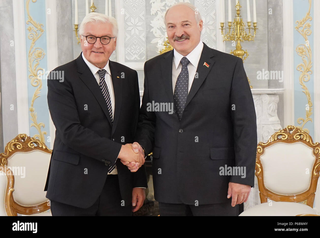 29 June 2018, Belarus, Minsk: German  President Frank-Walter Steinmeier (L, Social Democratic Party) and Alexander Lukashenko, Belarusian President, shake hands during the inauguration of the Malyj Trostenez Memorial. Malyj Trostenez was an Nazi extermination camp on former Soviet Union territory. Like many other extermination camps on Soviet territory, this camp is just known to few people in Germany and Europe. Photo: Jörg Carstensen/dpa Stock Photo