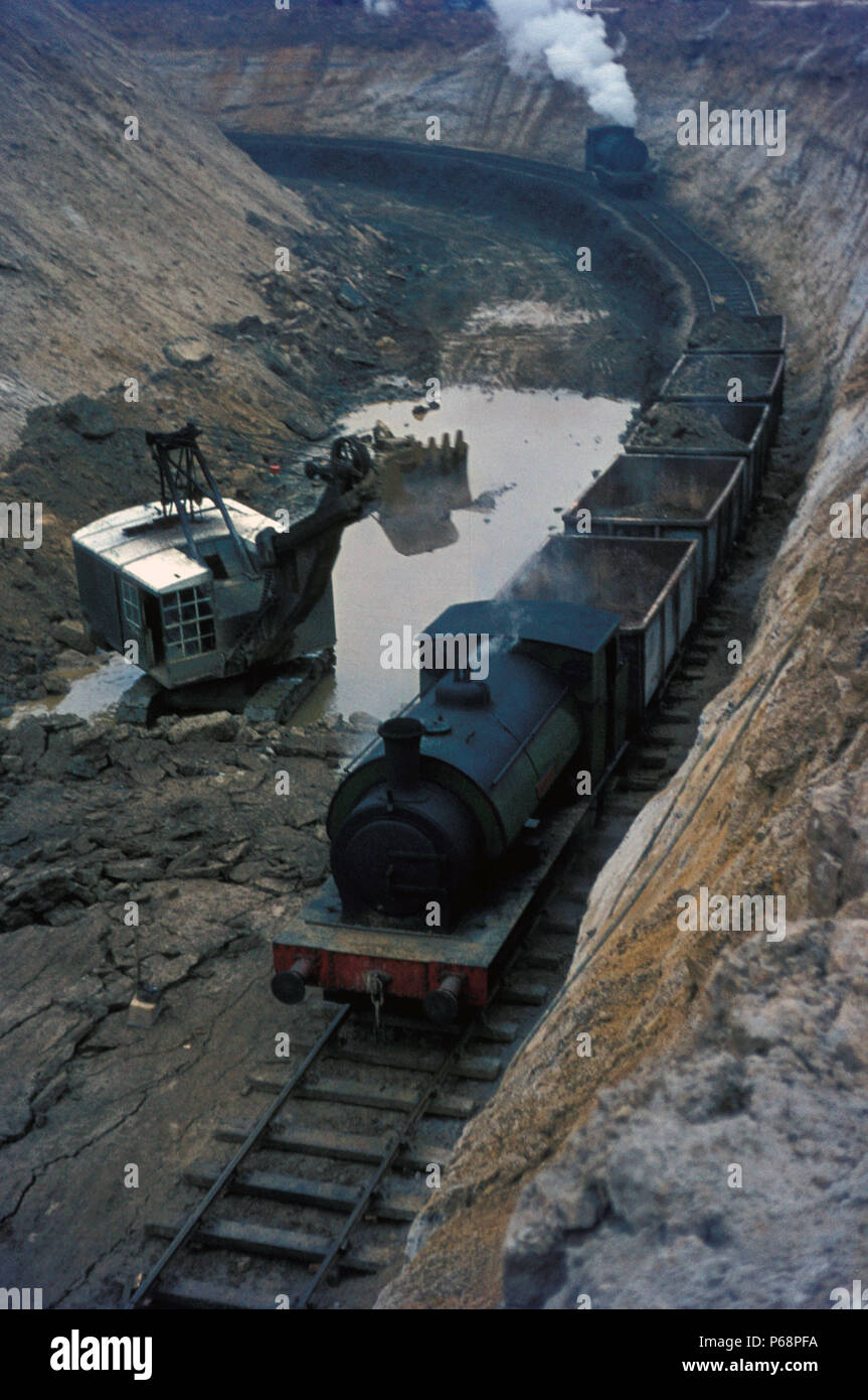 The working gullet at Nassington showing tippler wagons being loaded and unmined ore bed in the foreground. Assisting locomotive approaching to help d Stock Photo