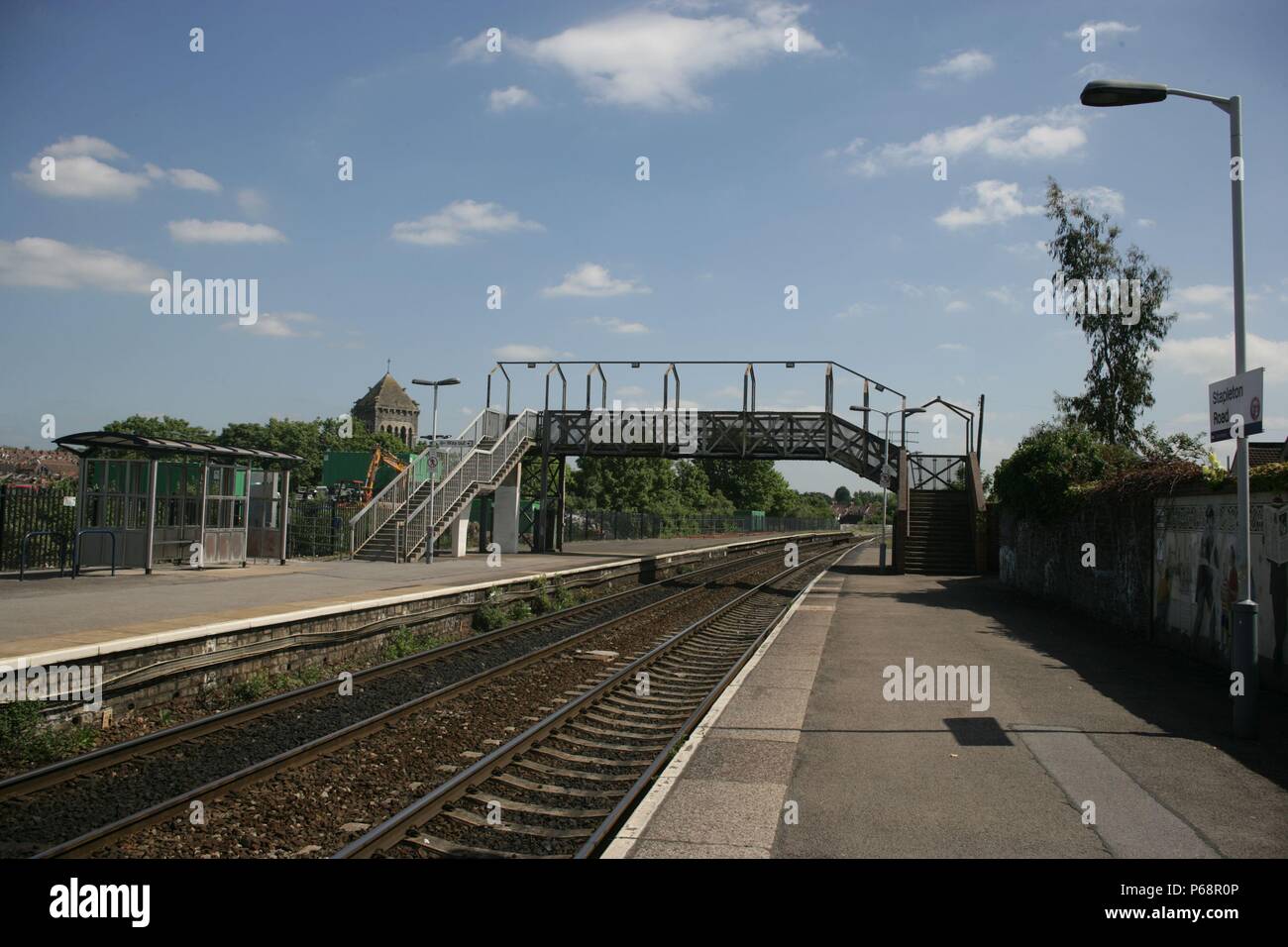 View of the platform with footbridge and platform lighting at Stapleton Road station near