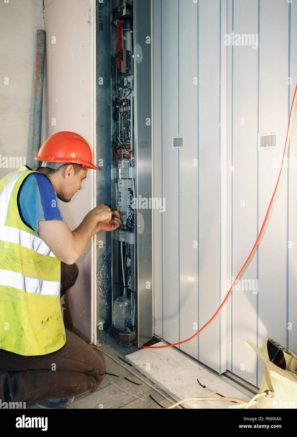 Electrician working on power supply in new building Stock Photo