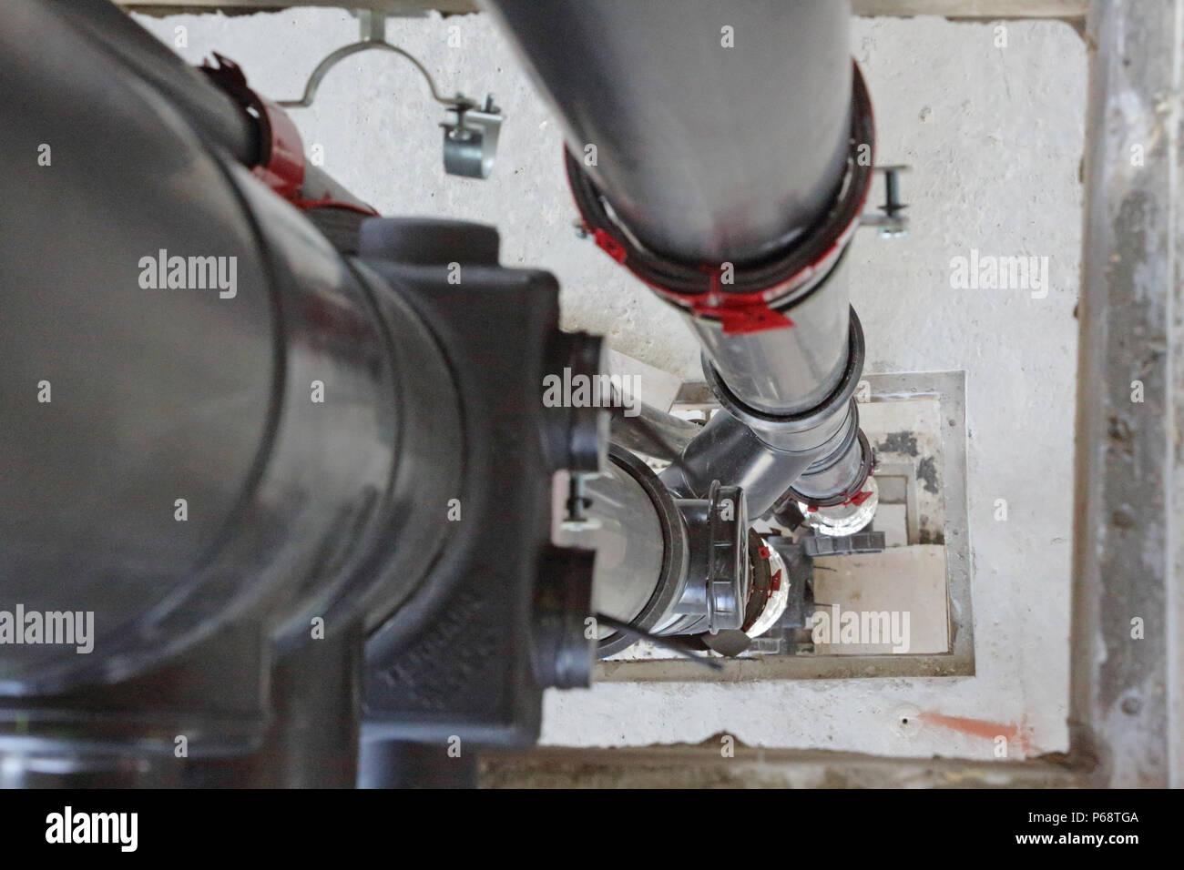 Plastic soil and waste pipes being installed in a new tower block in