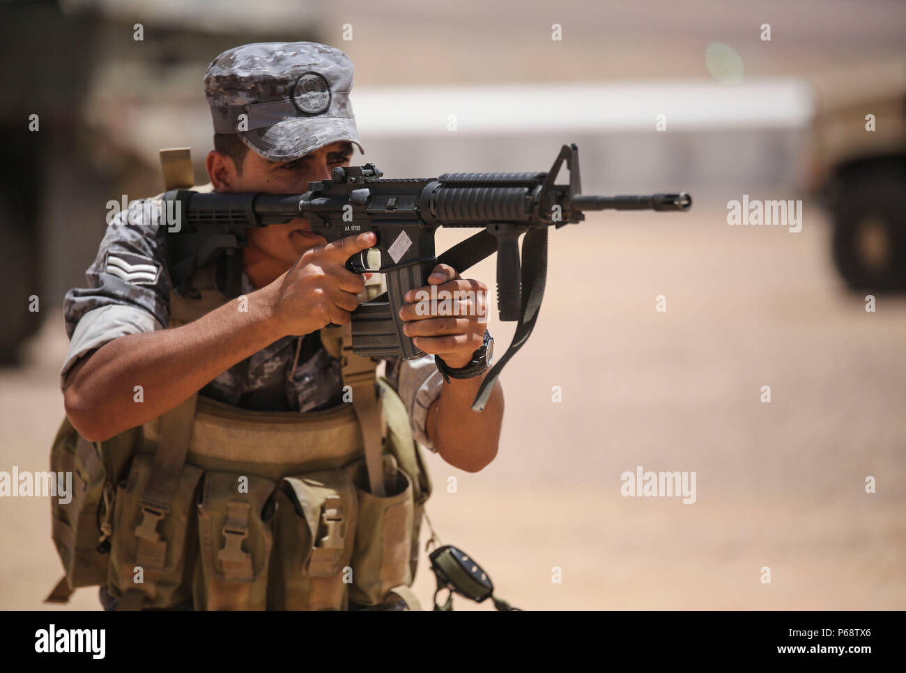 A member of the Jordanian 77th Marines Battalion aims an M4 carbine rifle  down range during their meet with Marines of 1st Battalion, 2nd Marine  Regiment, 2nd Marine Division in Al Quweyrah,