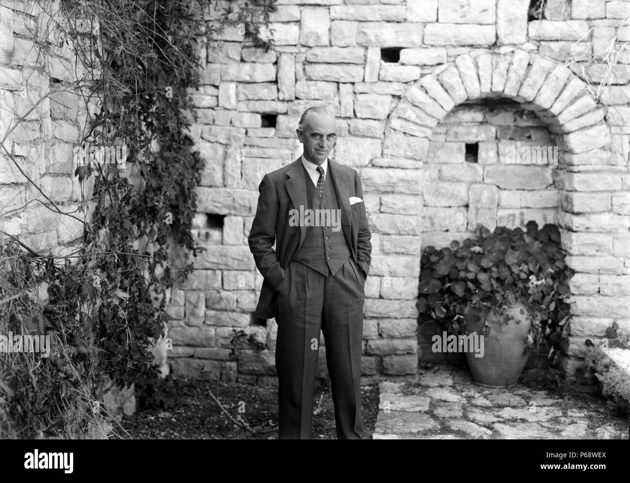 Sir Harold MacMichael, High Commissioner for Palestine at a sunken garden in his residency. MacMichael was a British colonial administrator and also served as Governor of Tanganyika. Stock Photo