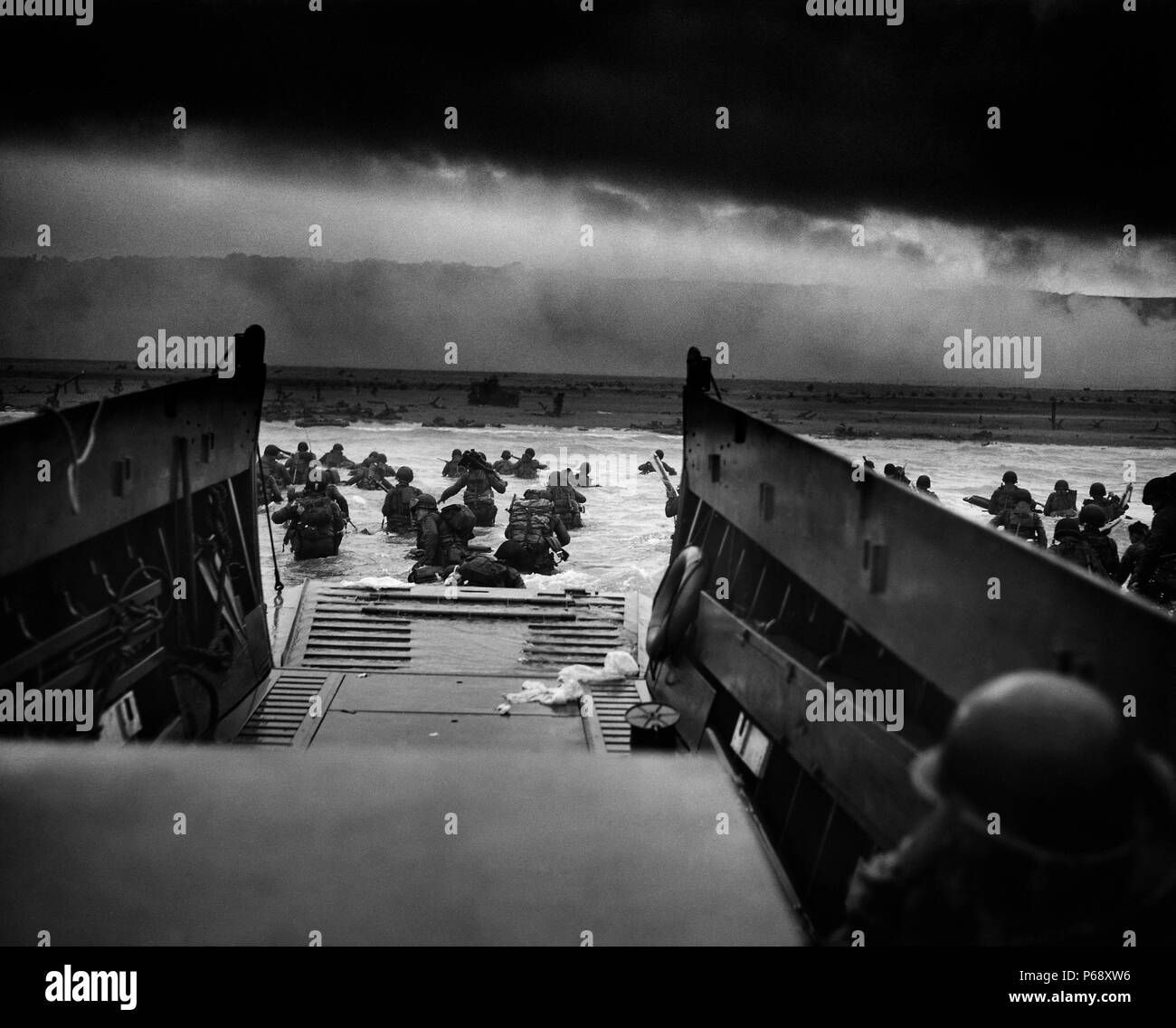 Photograph of U.S Troops rushing to the Normandy Beaches in France during the D-Day landing. Dated 1944 Stock Photo