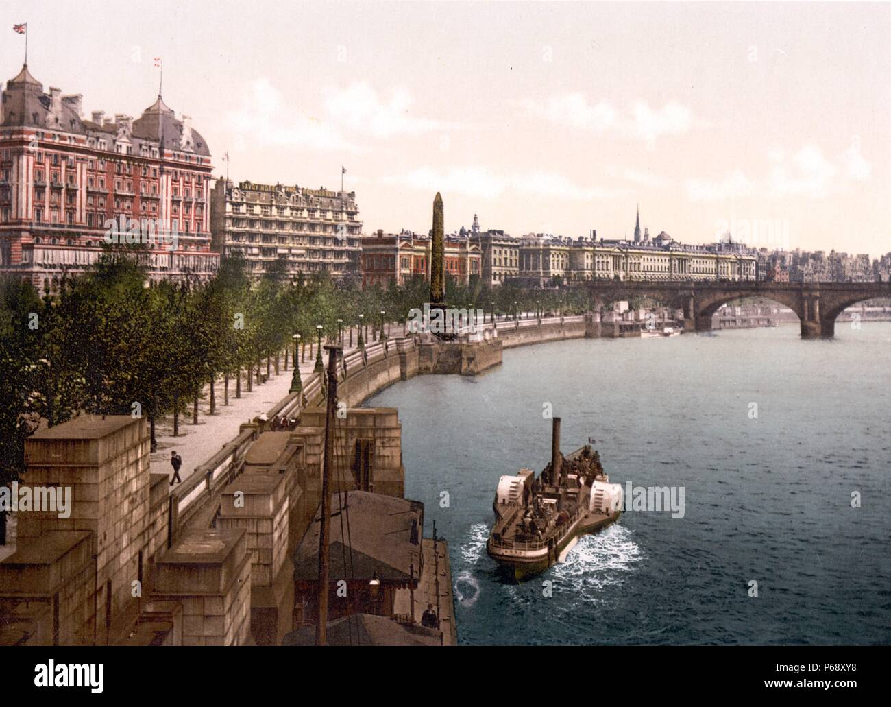 Colour photograph of a steam paddle boat along the North embankment of the River Thames in London showing Waterloo Bridge Area. Dated 1900 Stock Photo