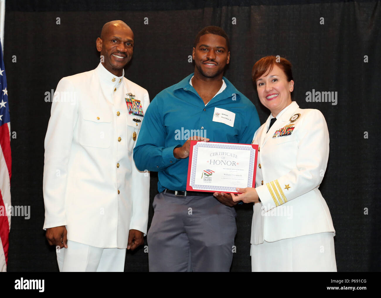 SAN ANTONIO – (May 18, 2016) Cmdr. Karen Muntean, commanding officer and Command Master Chief Eric Mays, Navy Recruiting District San Antonio pose with William Thornton Jr., a future Sailor, who was honored during Our Community Salutes-San Antonio’s 5th Annual “A Night in Your Honor” held in the Rosenberg Sky Room at the University of the Incarnate Word.  Each honoree received an Our Community Salutes certificate and challenge coin. (Navy Photo by Burrell Parmer, Navy Recruiting District San Antonio Public Affairs/Released) Stock Photo