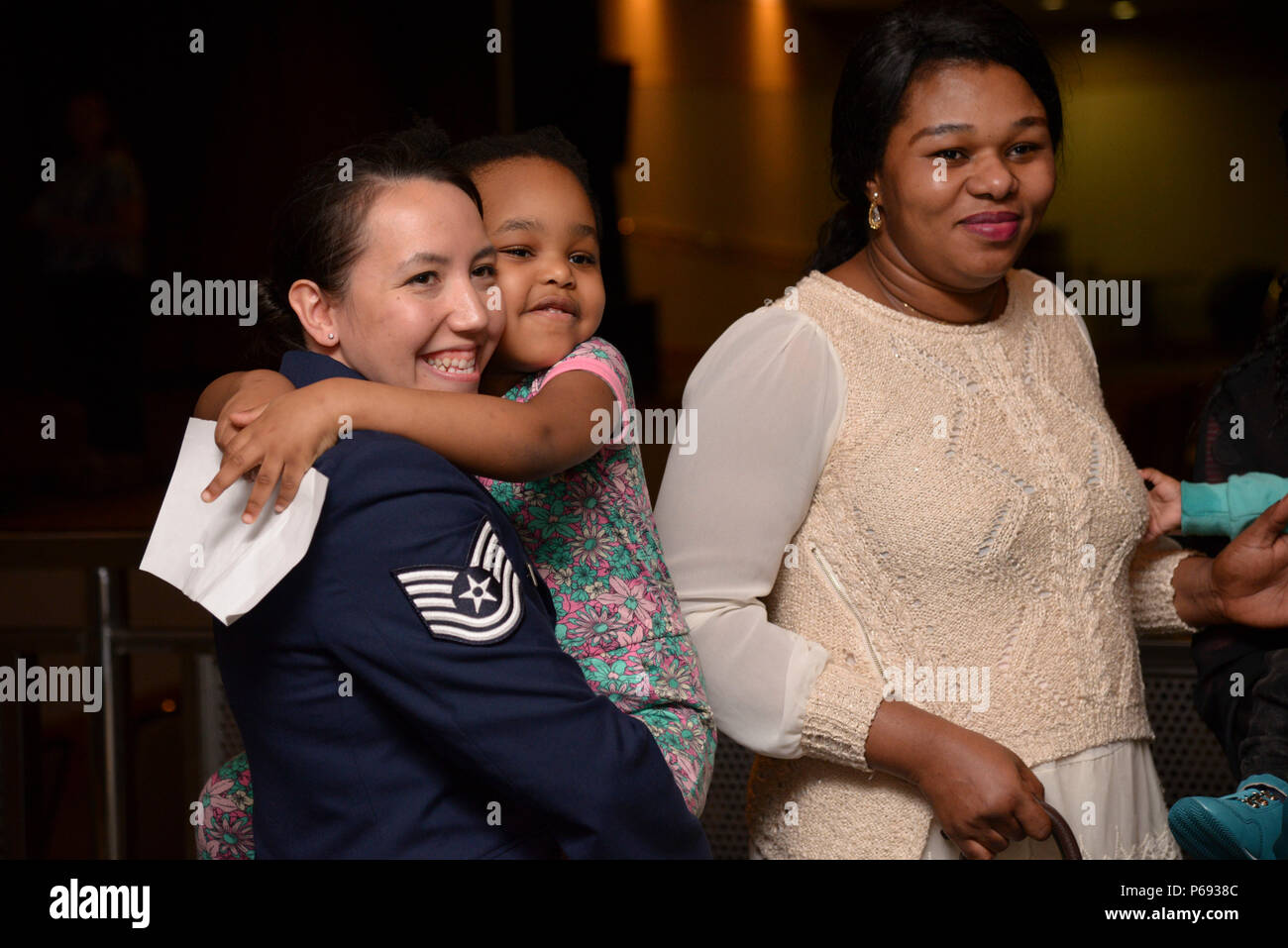 Tech. Sgt. Tina Kay, 607th Weather Squadron, hugs the daughter of Precious  Enyioko (right) after the Songtan fire rescue recognition ceremony at Osan  Air Base, Republic of Korea, May 13, 2016. Kay