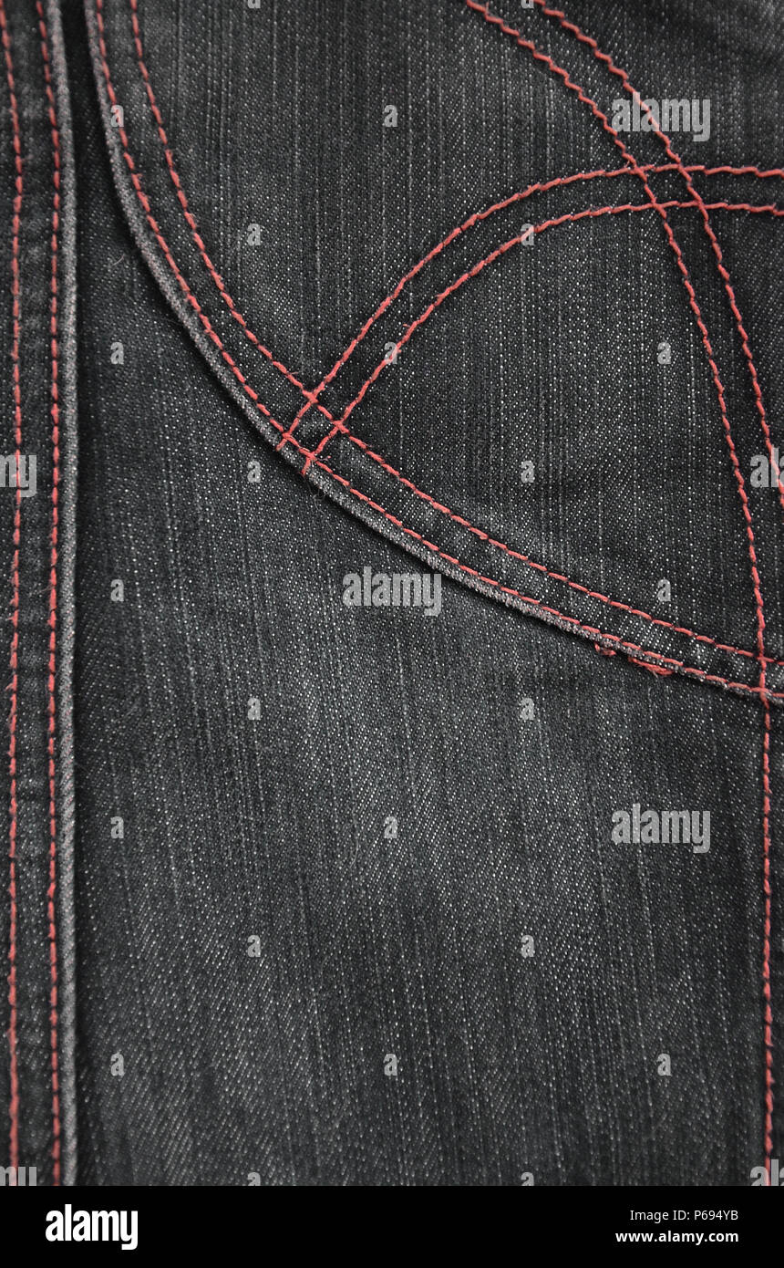 The texture of denim in classic monochrome tone with bright seams of ...