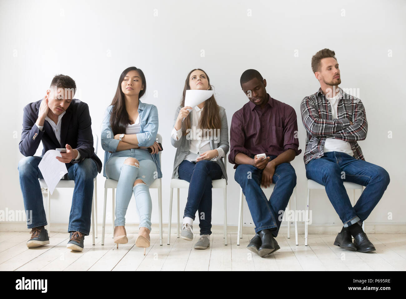 Interview Bored Diverse work candidates bored while waiting for interview Stock Photo ...