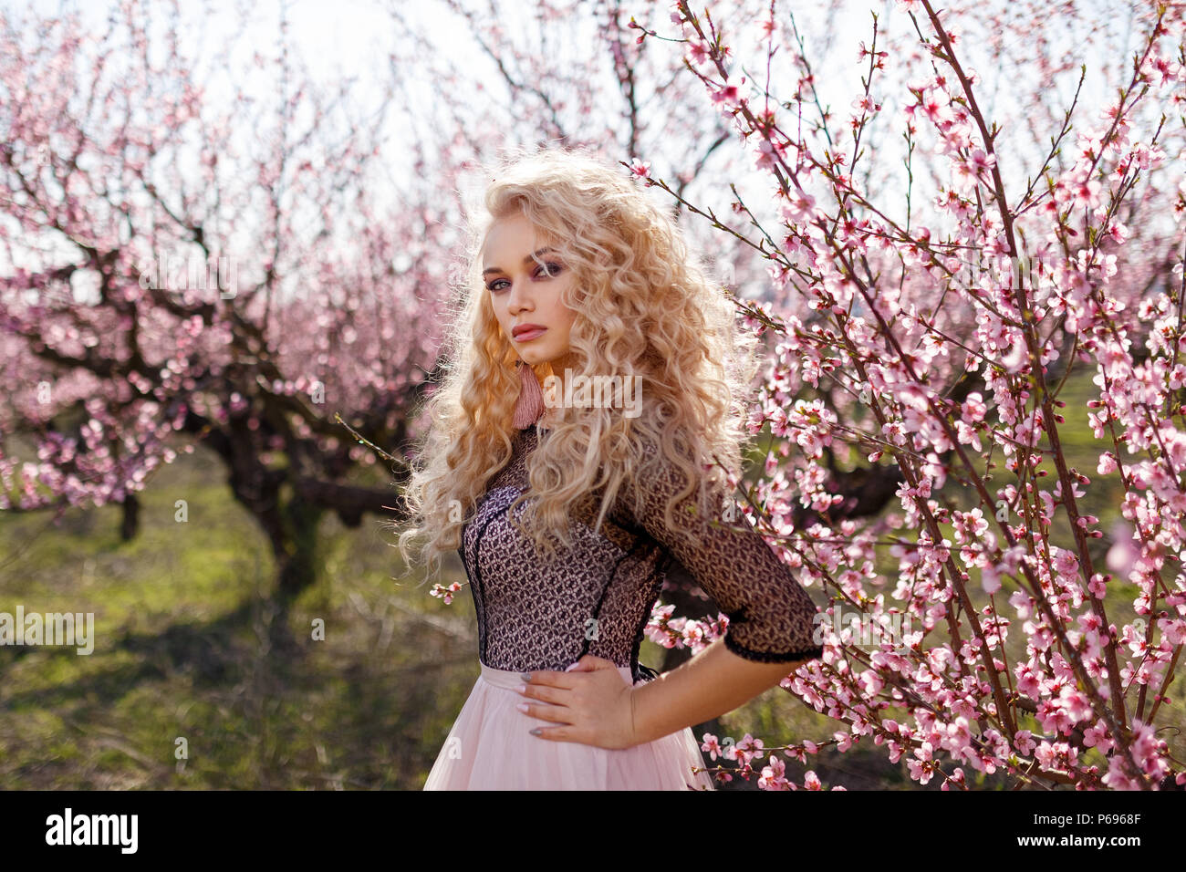 Beautiful portrait of a woman in a garden of flowering peaches Stock ...