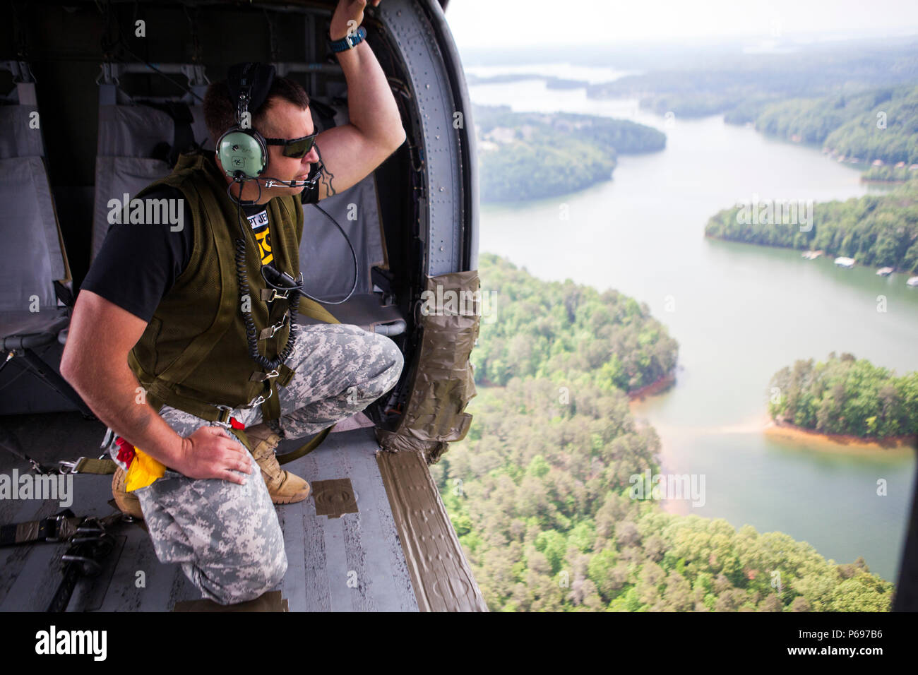 A U.S. Army Ranger Jumpmaster looks from a UH-60 Black Hawk over Lake ...