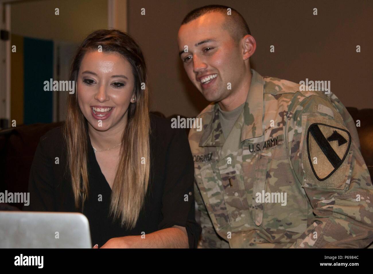 2nd Lt. Henry Rodriquez, a tank commander assigned to Company A, 3rd Battalion, 8th Cavalry Regiment, 3rd Armored Brigade Combat Team, 1st Cavalry Division, and his wife Brittany smile at the start of a video teleconference with Jeremy Osheim and Molei Wright May 24. Osheim and Wright were victims of a serious car accident in Colorado and were helped by the Rodriquez’s, who were on vacation in Breckenridge at the time. (U.S. Army photo by Staff Sgt. Leah R. Kilpatrick, 3rd Armored Brigade Combat Team Public Affairs Office, 1st Cavalry Division (released) Stock Photo