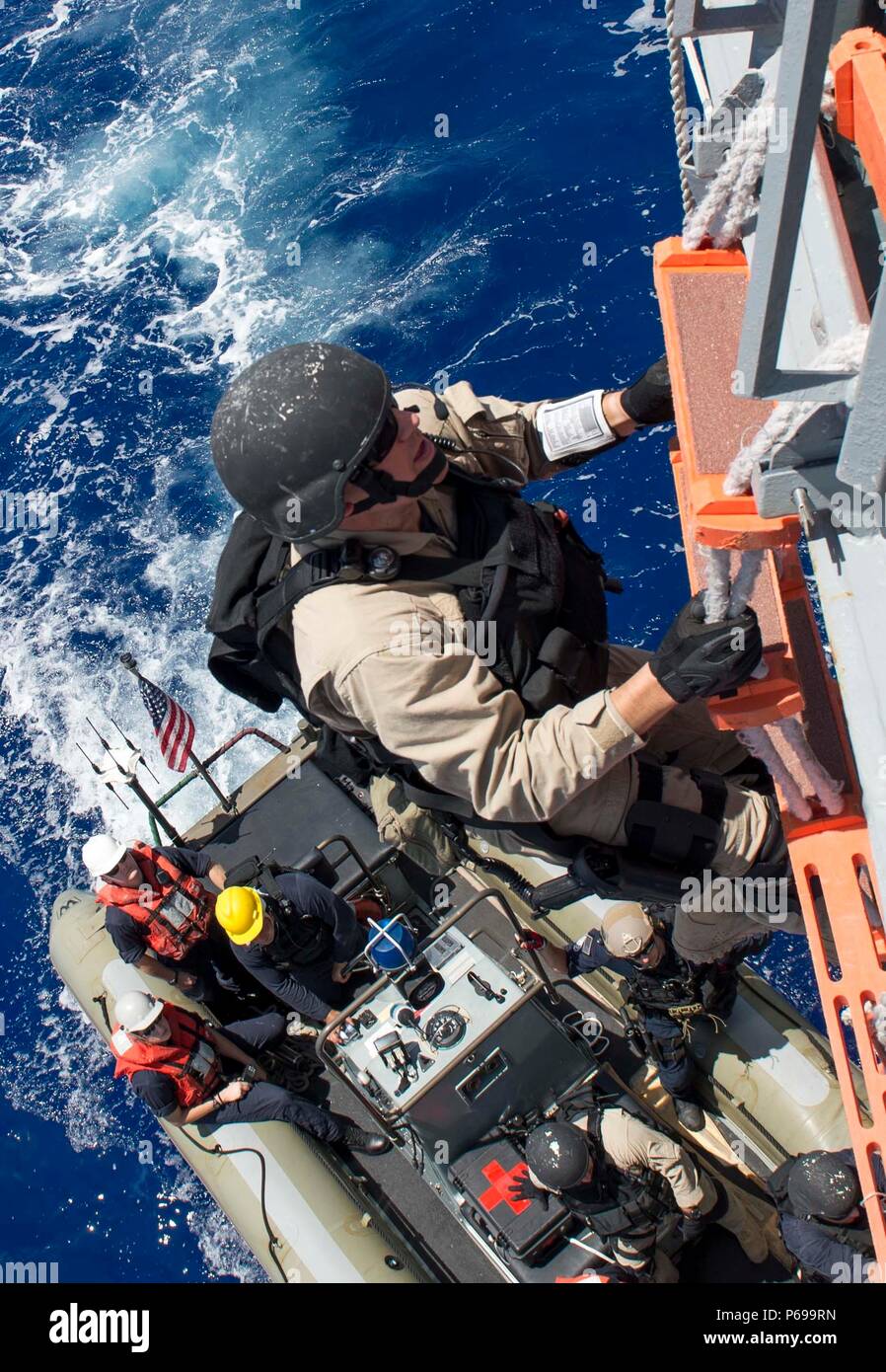 1605024-N-SU278-127  PACIFIC OCEAN (May 24, 2016) – Operations Specialist 1st Class Zachary Smith, assigned to the guided-missile destroyer USS Spruance (DDG 111), debarks a rigid-hull inflatable boat after conducting a boarding and inspection of a foreign fishing vessel as part of Oceania Maritime Security Initiative (OMSI).  Spruance, along with the guided-missile destroyers USS Momsen (DDG 92) and USS Decatur (DDG 73), and embarked “Devil Fish” and “Warbirds” detachments of Helicopter Maritime Strike Squadron (HSM) 49, are deployed as part of a U.S. 3rd Fleet Pacific Surface Action Group (P Stock Photo