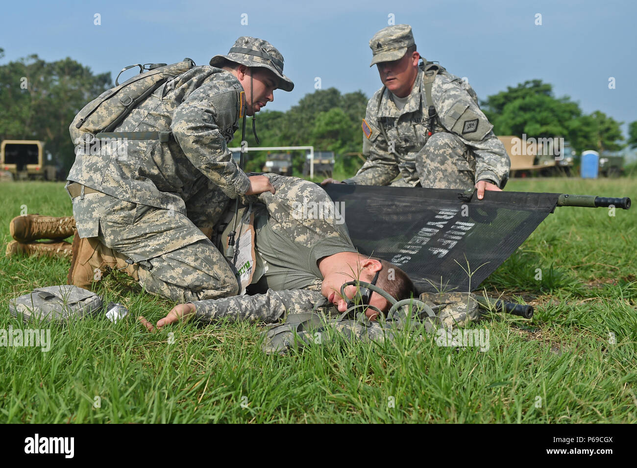 COATEPEQUE, Guatemala – Arkansas National Guardsmen Spc. Michael Williams, left, 296th Ground Ambulance Medical Company medic, and Sgt. John Ballard, right, 871st Troop Command Headquarters and Headquarters Company medic, position a simulated injured Soldier onto a litter during a medical readiness exercise May 26, 2016, during Exercise BEYOND THE HORIZON 2016 GUATEMALA. Arkansas National Guard Spc. Cameron Chailland, 875th Forward Support Company loader and machinist, played the role of the patient while Williams and Ballard trained to perform field-medical treatment. (U.S. Air Force photo by Stock Photo