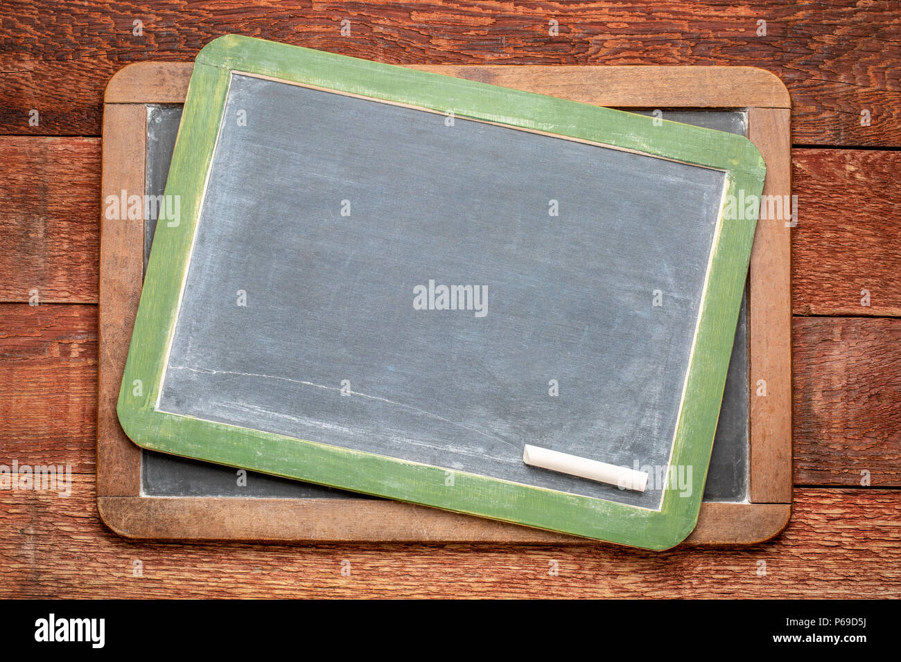 blank slate blackboards with a chalk against rustic barn wood Stock